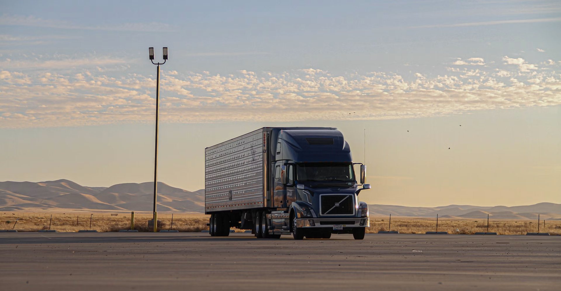 Truck on an open road at golden hour